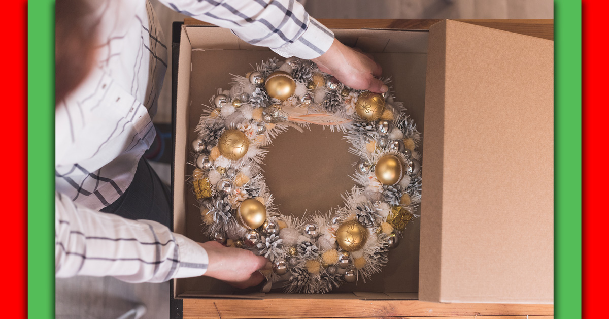 A woman packs a Christmas wreath away after the holidays.