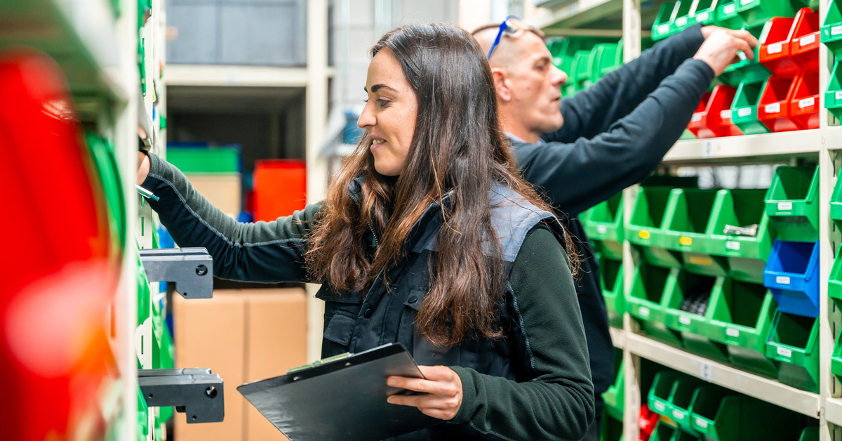 A woman organizes inventory in a warehouse.